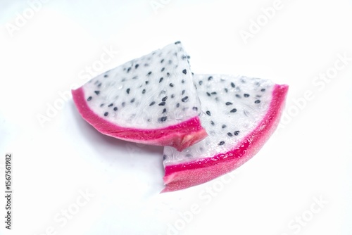 Fresh dragon fruit, sliced ​​into small pieces arranged on a white background.