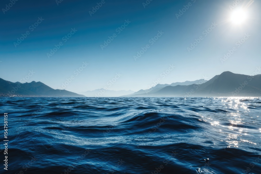Naklejka premium Realistic photo of the sea surface with a blue color and smooth waves, with the sun rising
