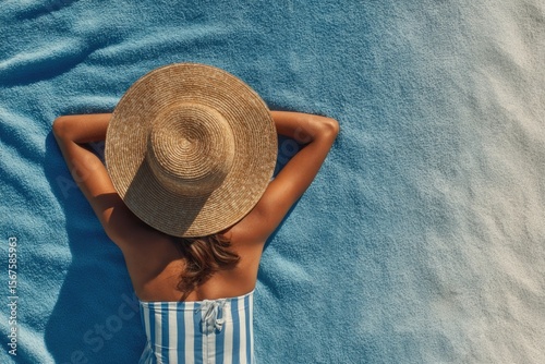 top view of a woman sunbathing on the beach