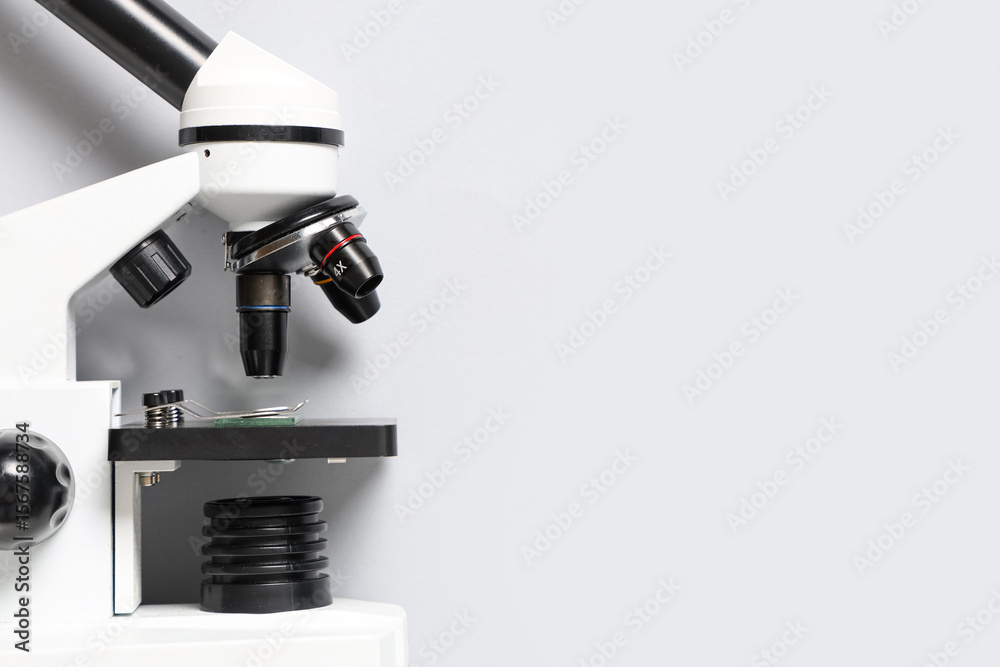 Fototapeta premium Closeup view of modern microscope on white background
