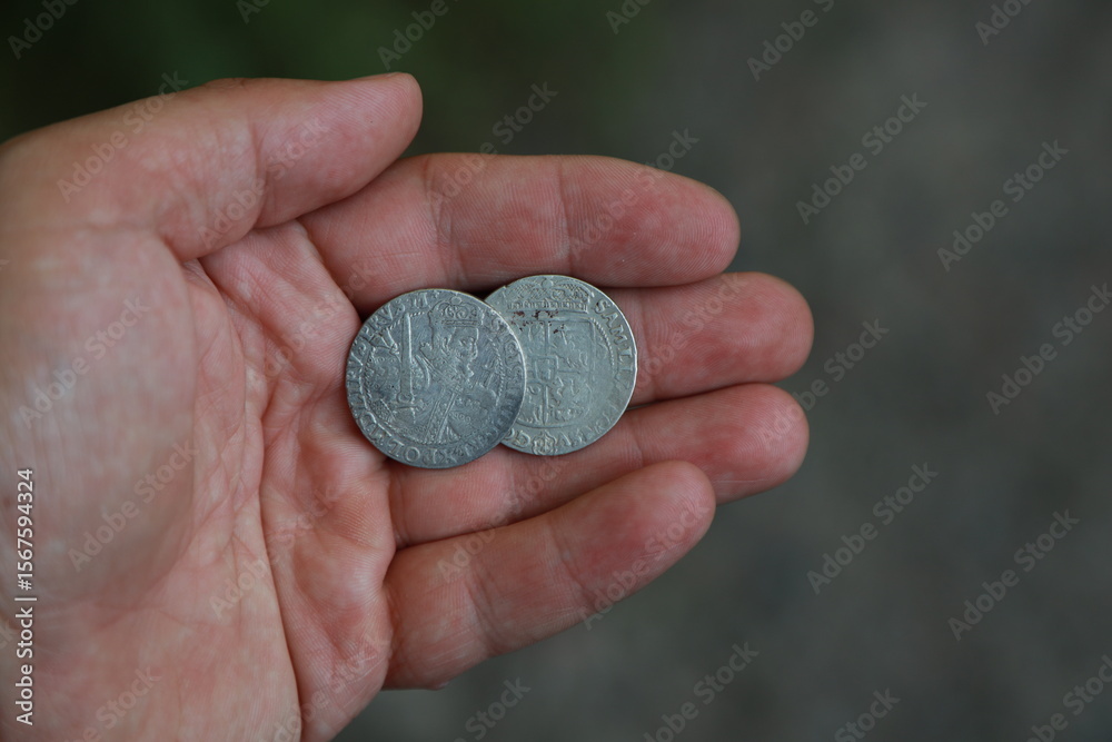 Medieval European silver coin in hand Medieval European silver coin in hand