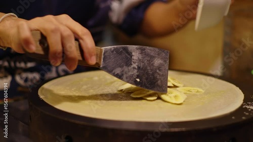 Street Vendor Prepares Banana Crepe on Hot Plate � Thai Street Food Close-Up
