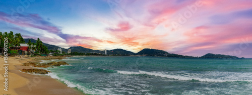 View of Patong Beach in the island of Phuket Thailand, turquoise blue waters of the Andaman and lush green mountains