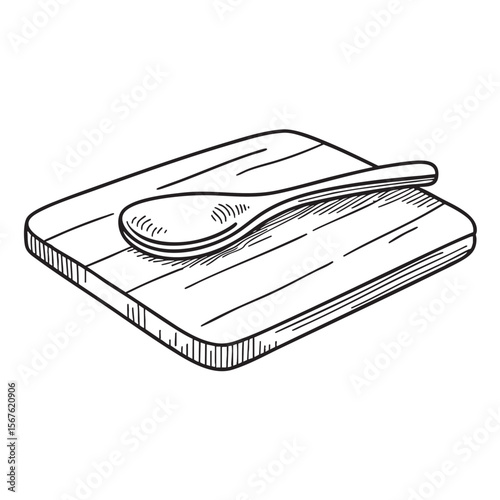 A cooking spoon placed on top of a cutting board