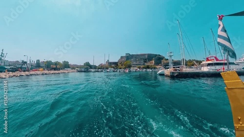 Traveling by boat with the back view on corfu island corfu city and marine