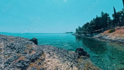 Walking down to the gorgeous rocky beach with crystal clear cyan water on Corfu island