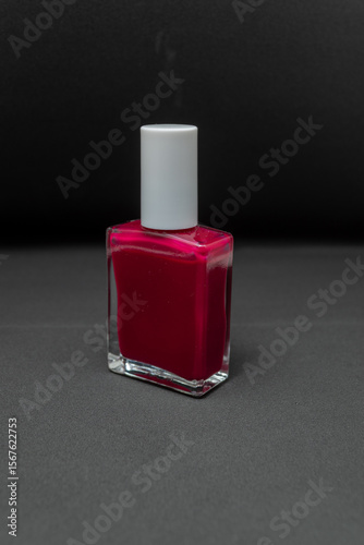 Manicure set black background nail red light from front 