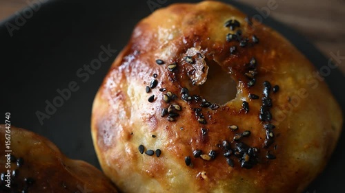 Baked samsa with golden crispy crust cooked in tandoor, traditional Uzbek and Central Asian cuisine, close-up.