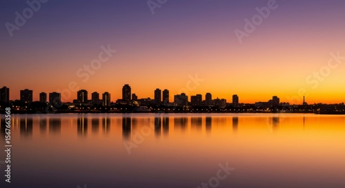 City skyline at sunset reflected on still water