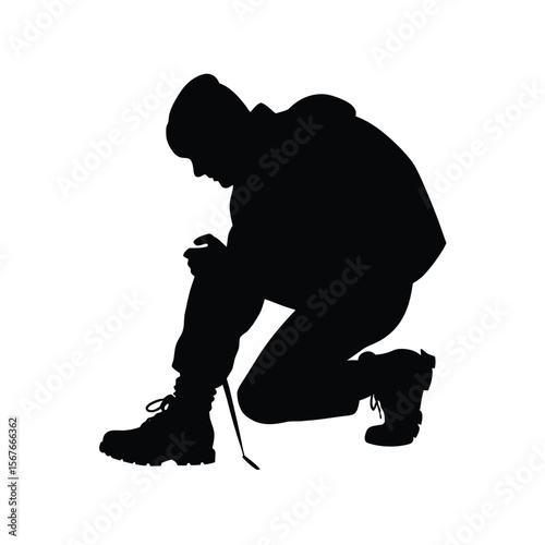 Black silhouette of person bending to tie boot lace
