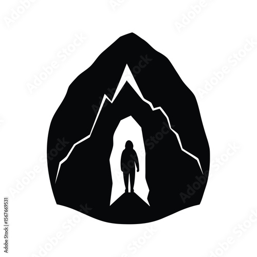 Black silhouette of person walking into mountain cave opening
