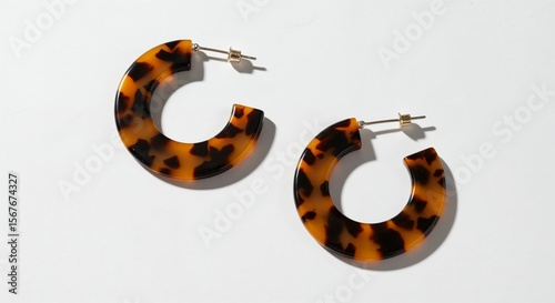 Tableau sur toile Hoop tortoiseshell earrings isolated on white, top-down photorealistic view, mar