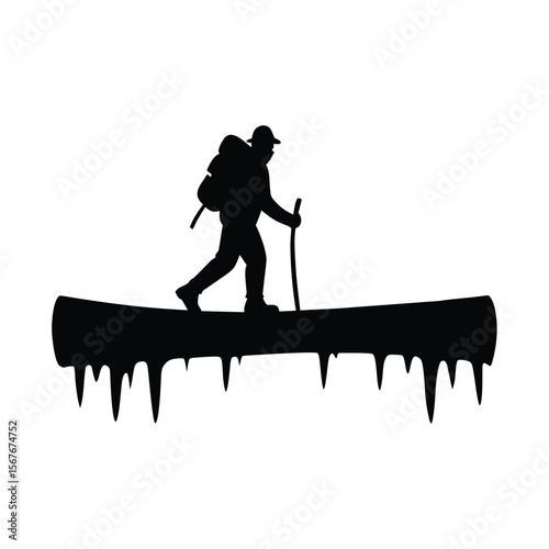 Silhouette of hiker crossing icy log bridge with pole