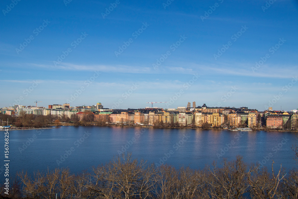 Scenic panoramic view of Stockholm city waterfront on a clear sunny day.
View of Stockholm city buildings across calm water on sunny day. Scenic panoramic view of Stockholm city waterfront on a clear sunny day.
View of Stockholm city buildings across calm water on sunny day.