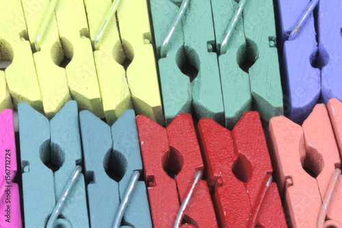 close up arrangement of colorful paper clips  or clothespin made of wood.
