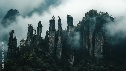 Misty mountain peaks with tall rock formations
