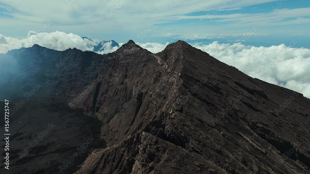 4K drone footage of Mount Raung at sunrise, revealing steep ridges, misty forests, and one of Indonesia’s most extreme hiking trails with cloud and vulcano 