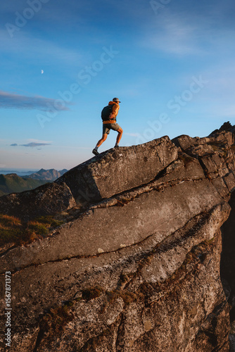 Active man trail running on mountain ridge in Norway travel hiking adventure outdoor, healthy lifestyle extreme vacations runner training endurance motivation sport concept