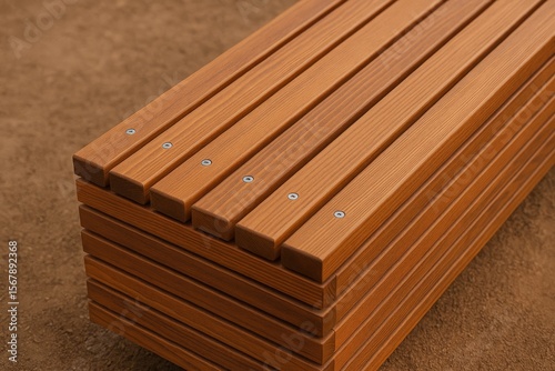 Detailed view of wooden slats used for seating with an unoccupied contemporary bench on a brown surface