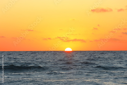 Fototapeta Naklejka Na Ścianę i Meble -  sunrise at sea with sun rays and waves