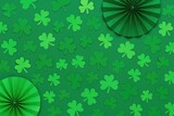 Vertical St. Patrick's Day backdrop with paper shamrocks and fans, featuring a green theme. Flat lay, top perspective.