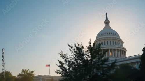 A majestic slow tilt-up shot of the U.S. Capitol, starting from the base and revealing the grand dome against the golden sunrise sky.