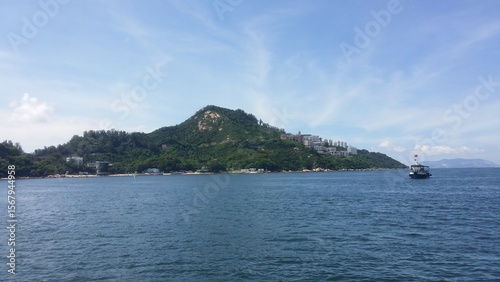 Coastal Mountain Lush Green Island with Blue Ocean and Bright Sky
