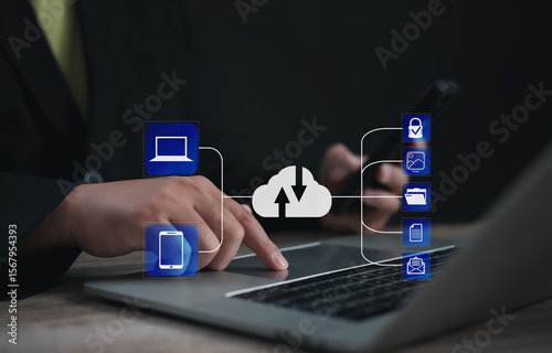 Entrepreneur syncing data between laptop and smartphone through cloud system, with secure icons for image, folder, file, and email, representing seamless digital integration and backup.