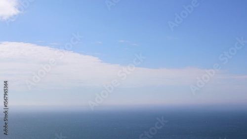 Wallpaper Mural Clouds Clearing Over Sea Timelapse. Moving Clouds Revealing Blue Sky. Coastal Sky Transformation Time Lapse. Morning Sky with Clouds Dissolving Torontodigital.ca
