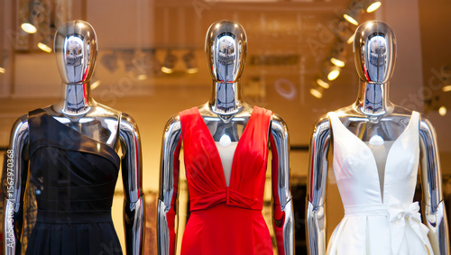 Chrome Fashion Mannequins Displaying Evening Dresses in Luxury Boutique Store Window Display