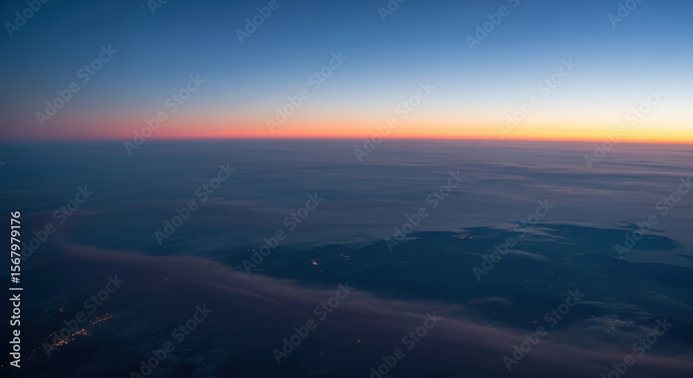 Fototapeta premium An aerial view of a sunset with clouds and a gradient sky from blue to orange and pink color palette
