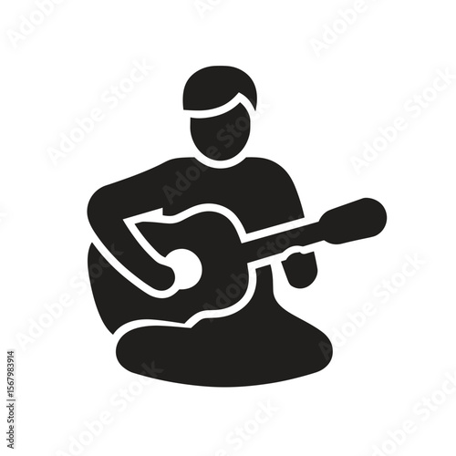 Silhouette of a person playing a stringed instrument, likely a guitar, while sitting down. The scene suggests musical expression and skill.
