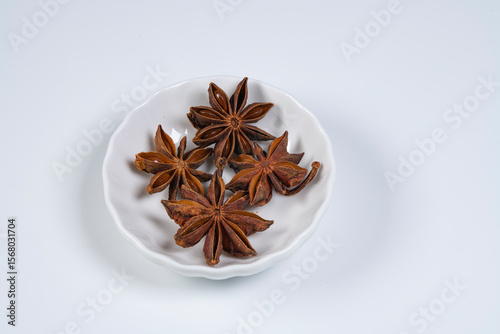 Fototapeta Naklejka Na Ścianę i Meble -  Star anise spice in white plate