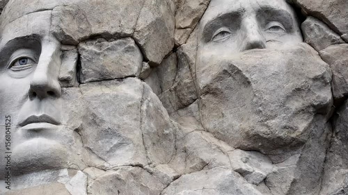 A close-up of the weathered rock surface around the Mount Rushmore faces, emphasizing the texture of the stone and the fine