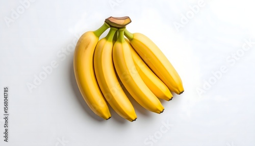 Top-down view of ripe bananas with smooth yellow peel, arranged in a small bunch. Isolated on clean white background with soft shadows, commercial fruit setup.