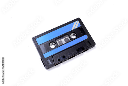 Black vintage audio cassette tape isolated on white background. Retro style background. Top view, flat lay, copyspace