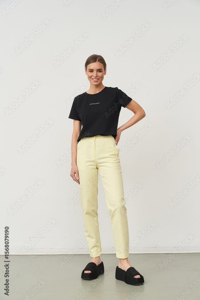 Woman poses in stylish outfit indoors, showcasing modern fashion trends Woman poses in stylish outfit indoors, showcasing modern fashion trends