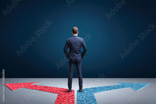 A man in a suit stands at a crossroads, facing two divergent arrows colored red and blue, symbolizing decision-making and choice.