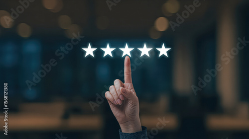 A hand is pointing at the center of a five-star rating displayed in a blurred background.