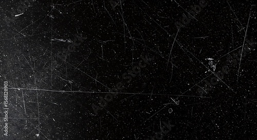 Distressed black surface with fine scratches and dust particles texture