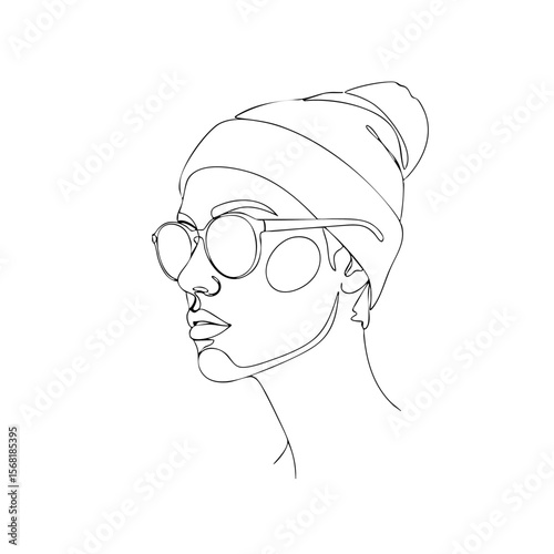 A woman in sunglasses and a beanie with a cool mood in profile