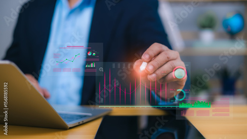 Business analytics and financial data visualization concept with person interacting with holographic charts