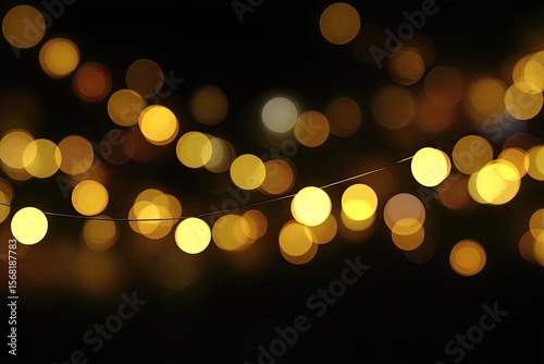 Golden string lights bokeh against a black background