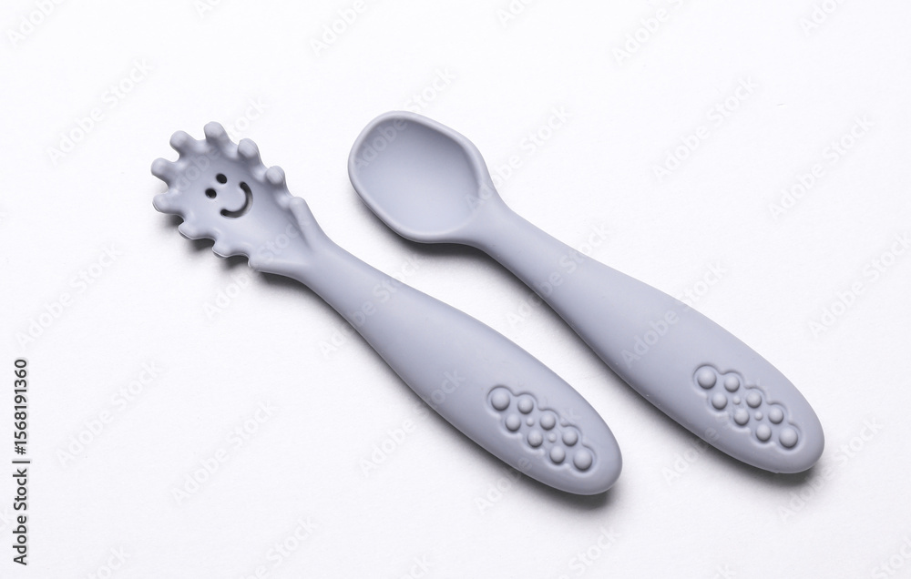 Obraz premium Cute silicone spoons for feeding little baby on white background