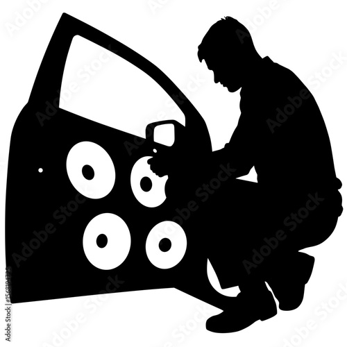 Silhouette of person installing car audio speakers, automotive sound customization