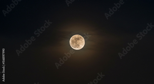 Luminous full moon glows softly against the vast expanse of a star-dusted night sky.