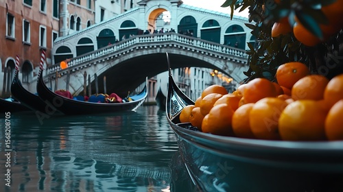 Gondola laden with oranges under Venetian bridge