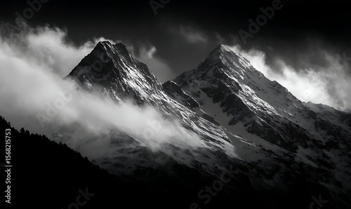 Majestic Mountain Silhouettes in Misty Light, A striking black and white image of towering mountain silhouettes, bathed in a soft, misty light.
