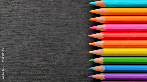Colored pencils on slate background