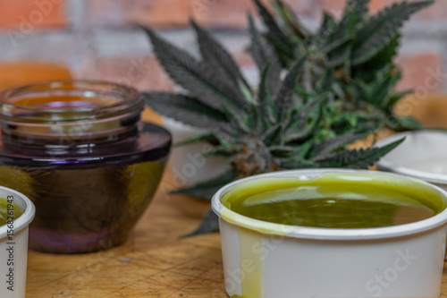 Home made marijuana medical salve with color brick wall